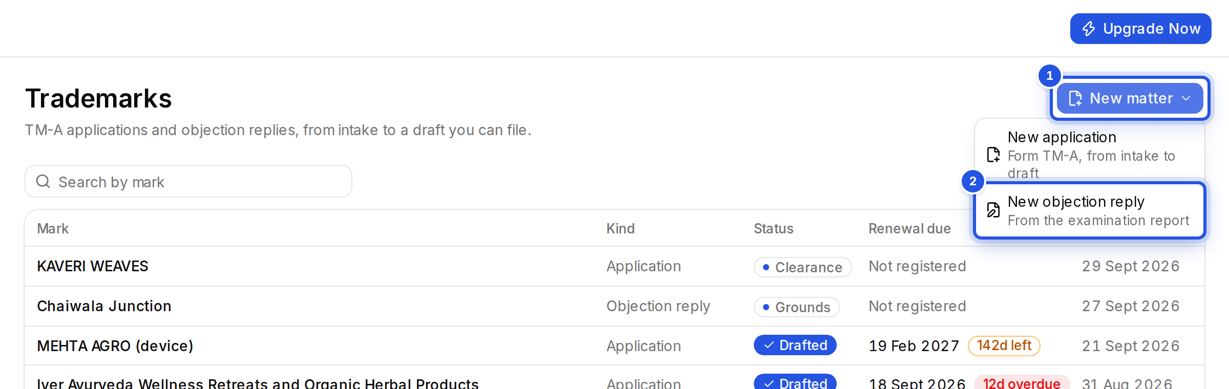 The Trademarks page with two numbered marks: 1 the New matter button and 2 New objection reply in its menu.